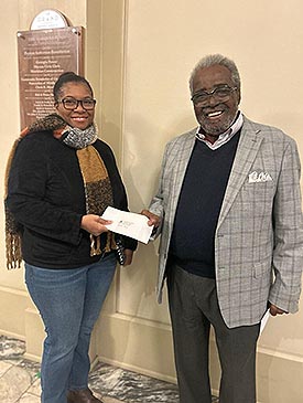 Dylanda Young, winner of the 'Whitney Houston Tribute' Contest, accepting her prize from Alex Habersham, publisher of the Macon-Middle Georgia Black Pages