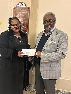 Patricia Bass, winner of the 'Whitney Houston Tribute' Contest, accepting her prize from Alex Habersham, publisher of the Macon-Middle Georgia Black Pages